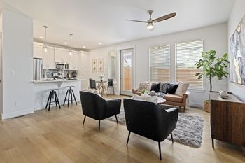 Modern living room with black chair and fan